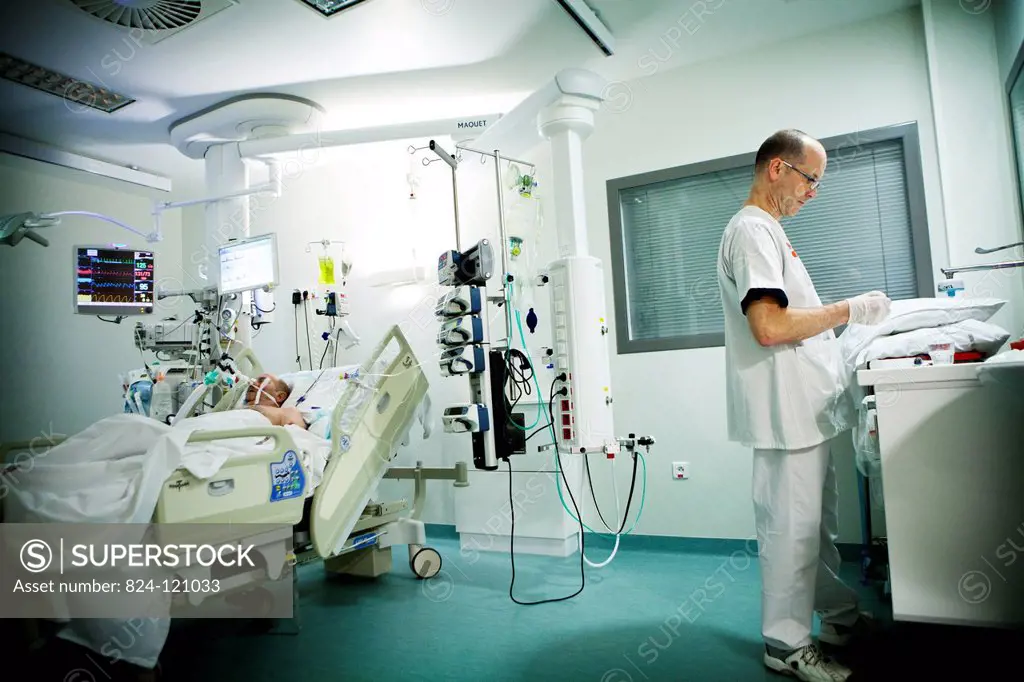 Reportage in Robert Ballanger hospital's Intensive Care Unit in France. A nursing auxiliary in a patient's room.