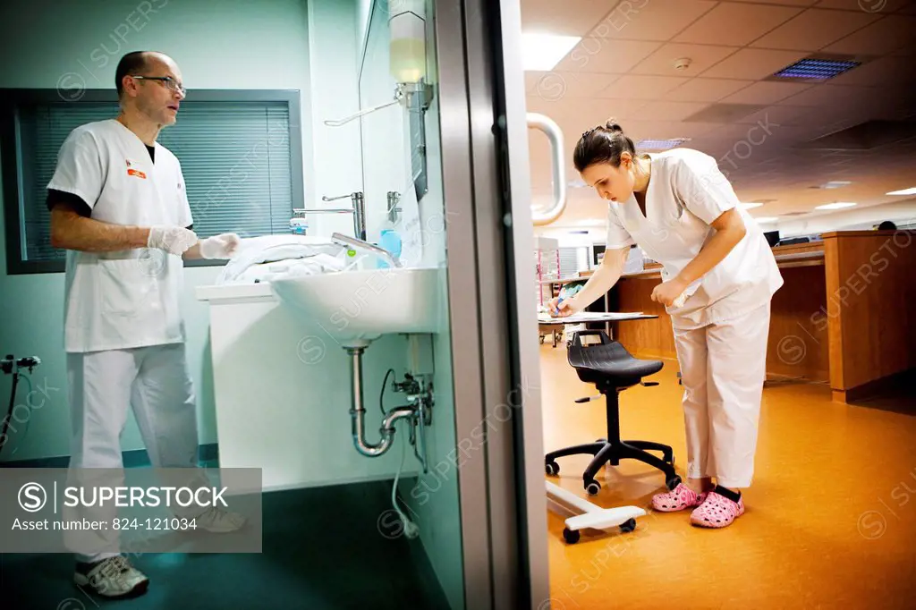 Reportage in Robert Ballanger hospital's Intensive Care Unit in France. A nursing auxiliary and a student nurse get ready to deal with a patient.