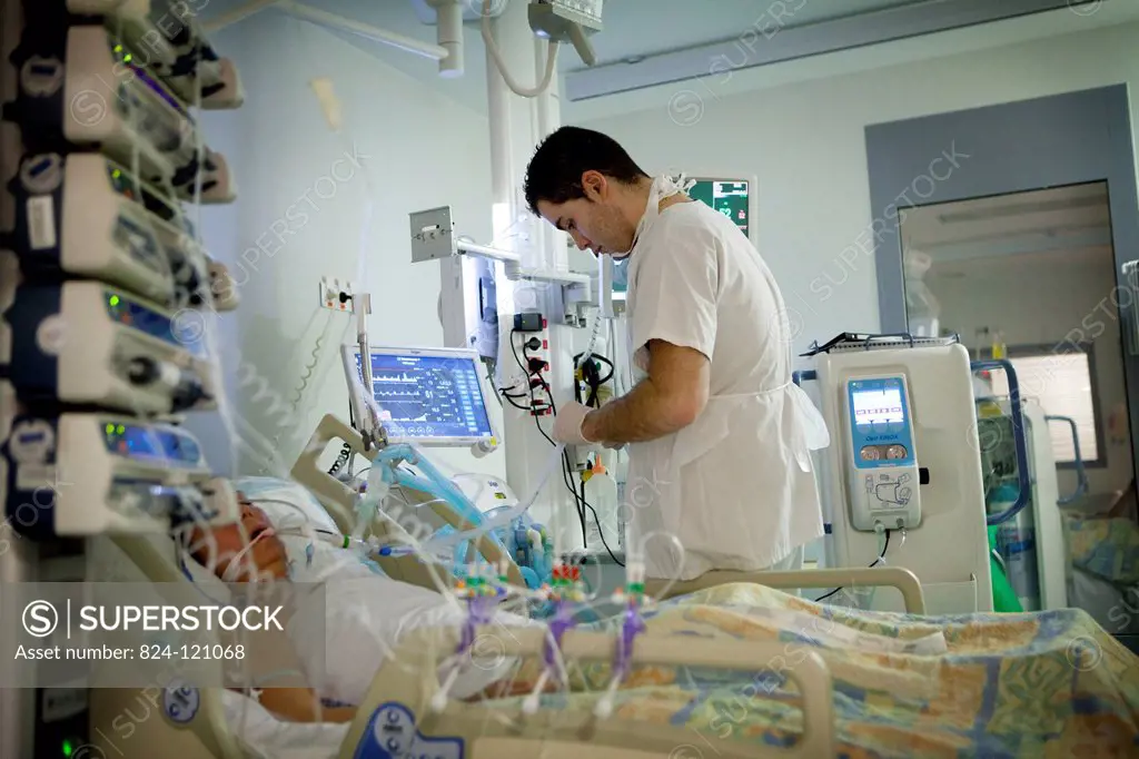 Reportage in Robert Ballanger hospital's Intensive Care Unit in France. A nurse looks after a curarised patient.