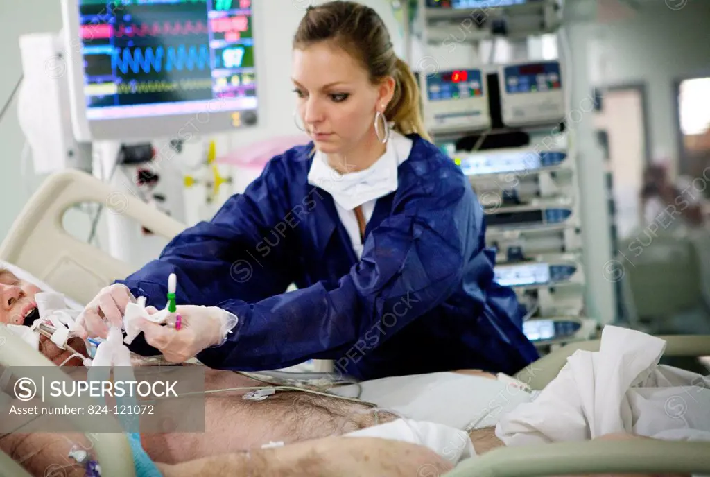 Reportage in Robert Ballanger hospital's Intensive Care Unit in France. A nurse cleans a patient's endotracheal intubation sensor.