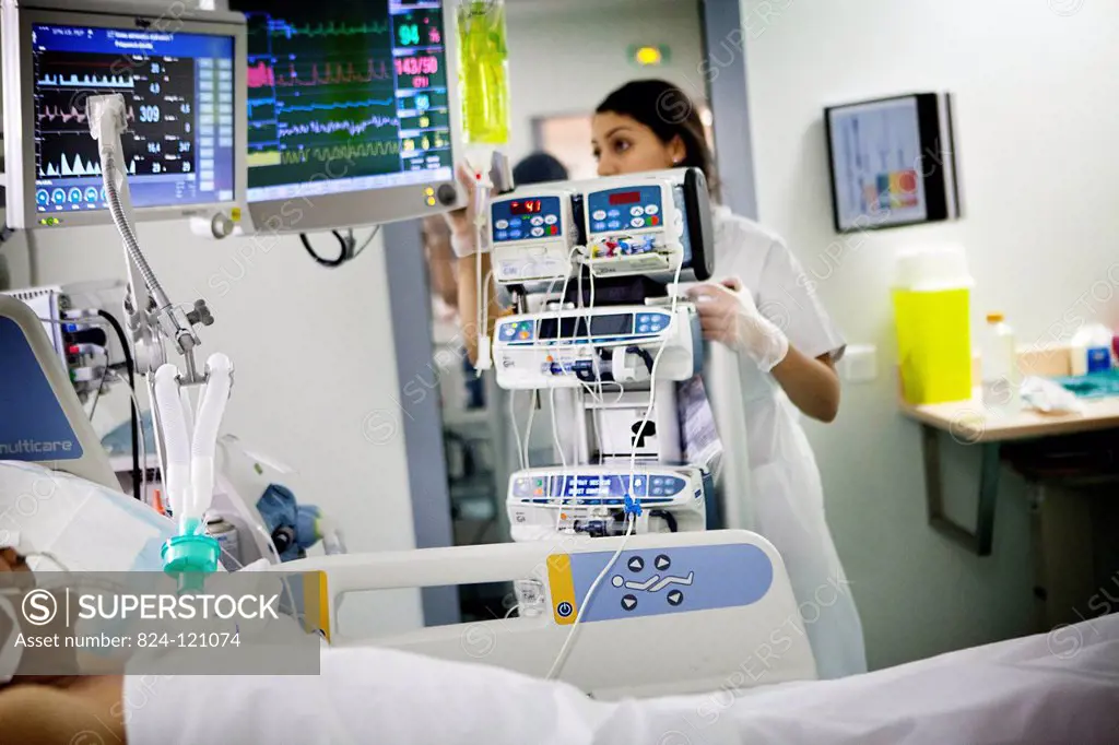 Reportage in Robert Ballanger hospital's Intensive Care Unit in France. A nurse checks a patient's vital parameters.