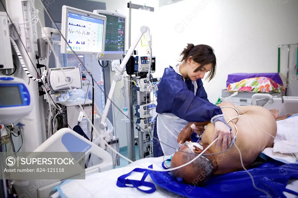 Reportage in Robert Ballanger hospital's Intensive Care Unit in France. A nurse looking after a patient.