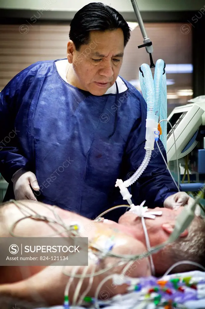 Reportage in Robert Ballanger hospital's Intensive Care Unit in France. A doctor examines a patient.
