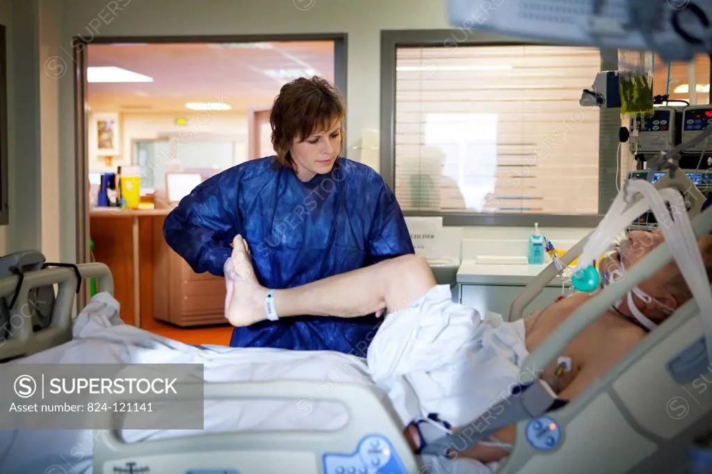 Reportage in Robert Ballanger hospital's Intensive Care Unit in France. A physiotherapist exercises a patient.