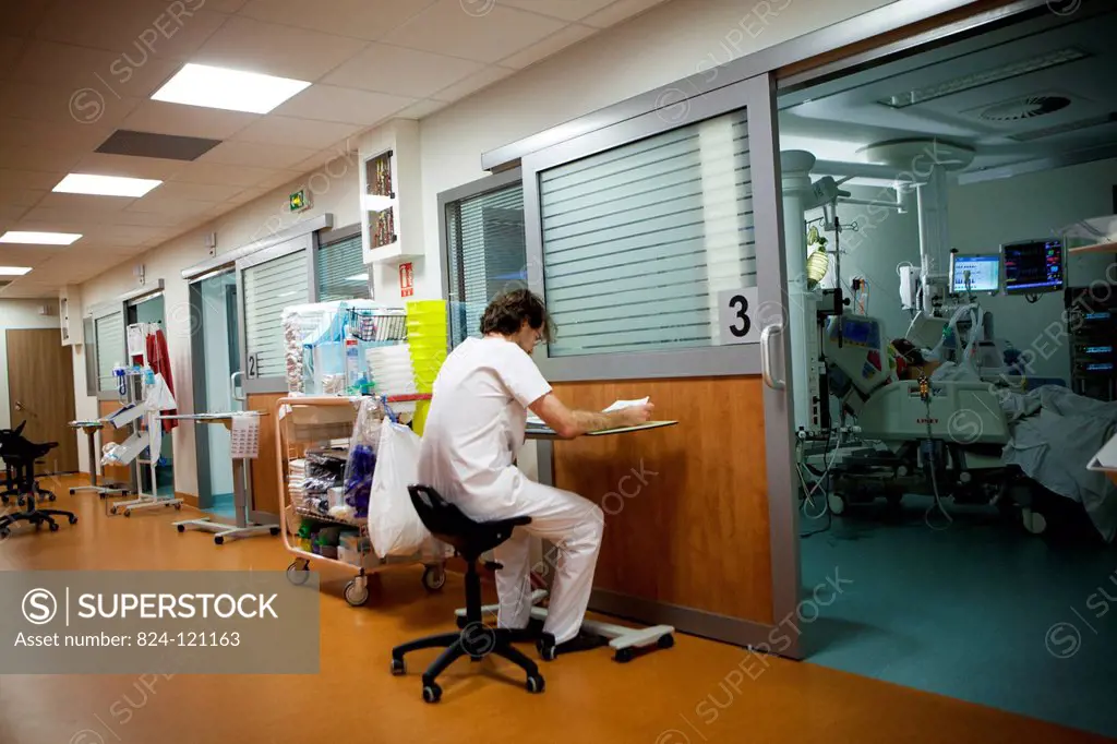 Reportage in Robert Ballanger hospital's Intensive Care Unit in France. A doctor fills in patients' files.