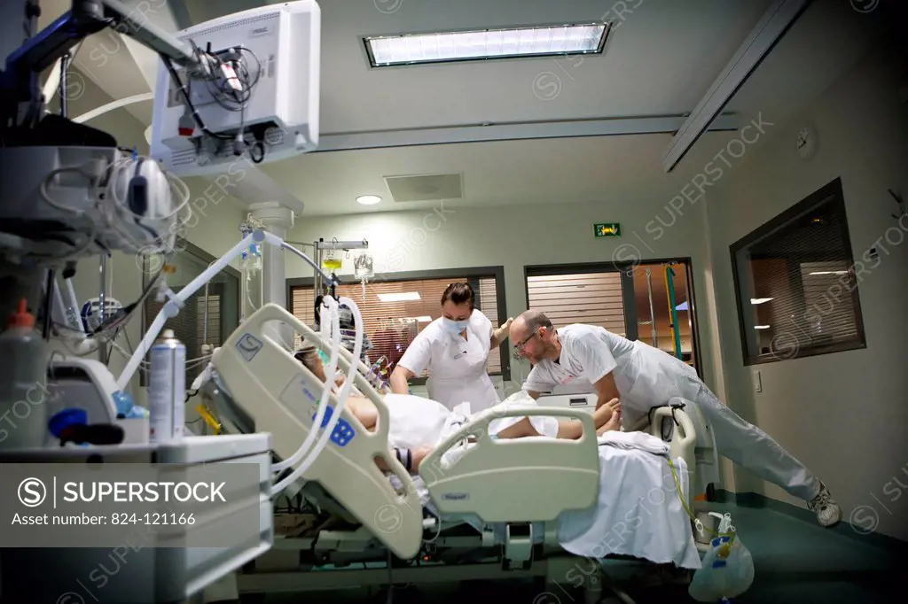 Reportage in Robert Ballanger hospital's Intensive Care Unit in France. A nurse and nursing auxiliary looks after a patient.