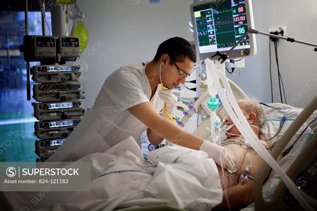 Reportage in Robert Ballanger hospital's Intensive Care Unit in France. An intern examines a patient.