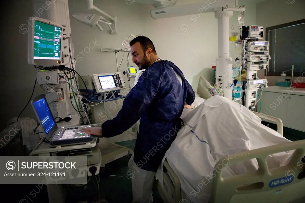 Reportage in Robert Ballanger hospital's Intensive Care Unit in France. A doctor performs a scan on a patient.