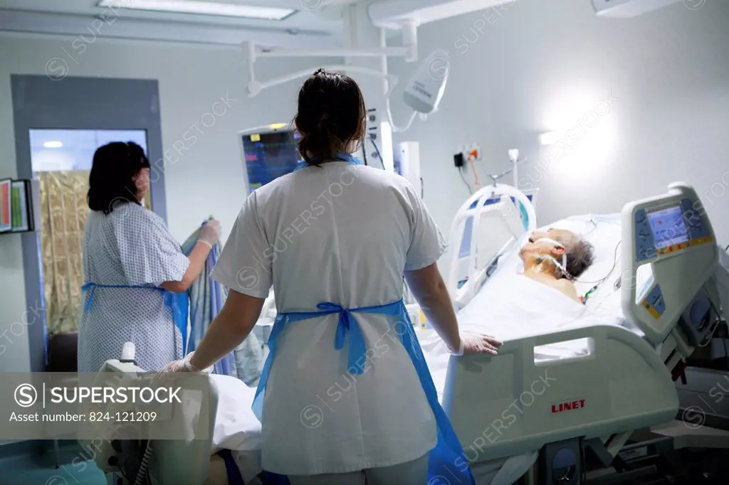 Reportage in Robert Ballanger hospital's Intensive Care Unit in France. Two nurses look after a patient.