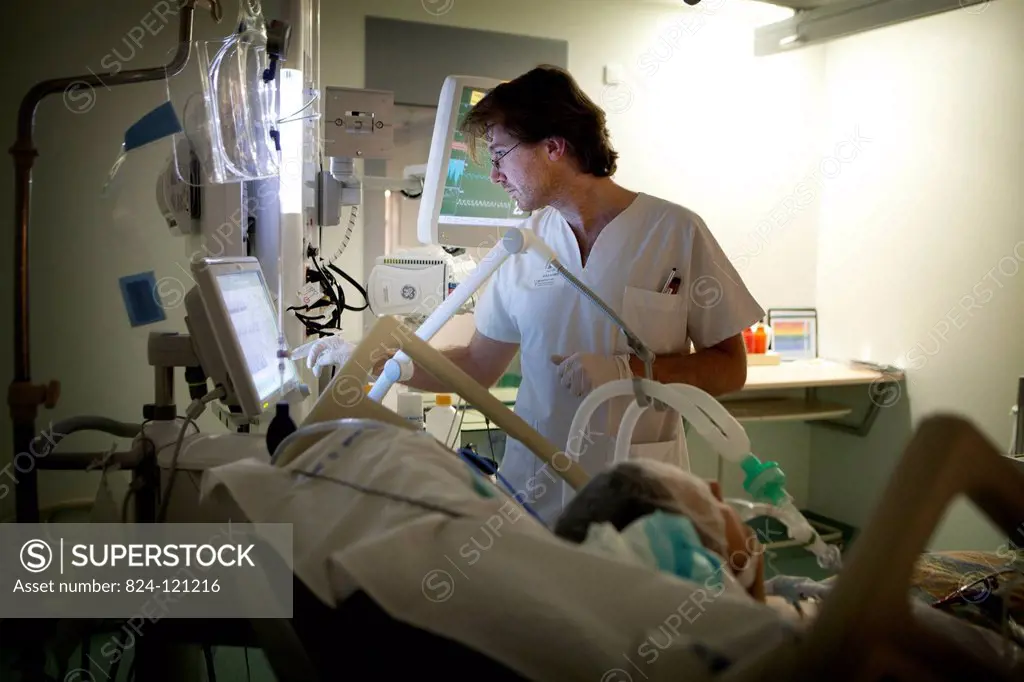 Reportage in Robert Ballanger hospital's Intensive Care Unit in France. A doctor checks a patient's vital parameters.