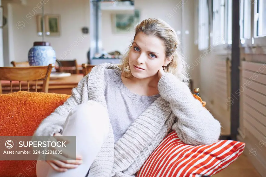 Woman sitting on her sofa.