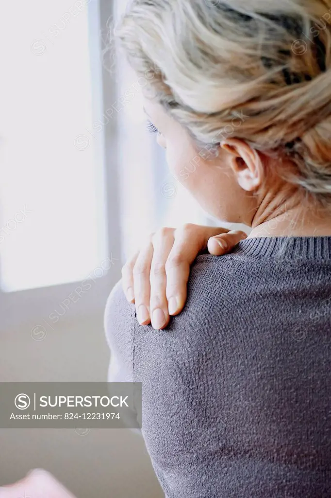 Woman suffering from shoulder pain.
