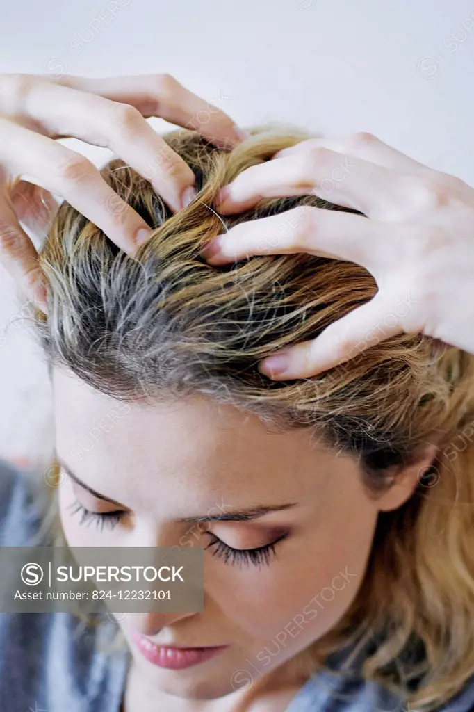 Woman massaging her scalp.