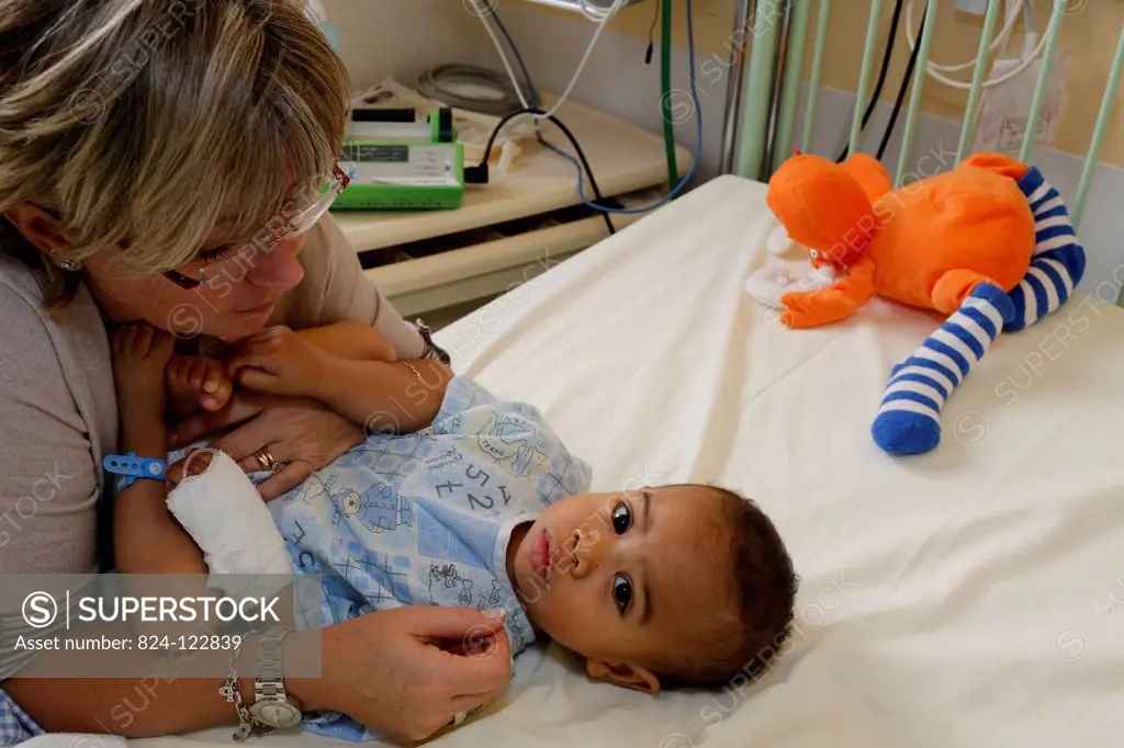 Child in hospital with his foster mother. This boy from Madagascar is about to undergo heart surgery provided by French NGO La Chaine de l'Espoir (Sur...