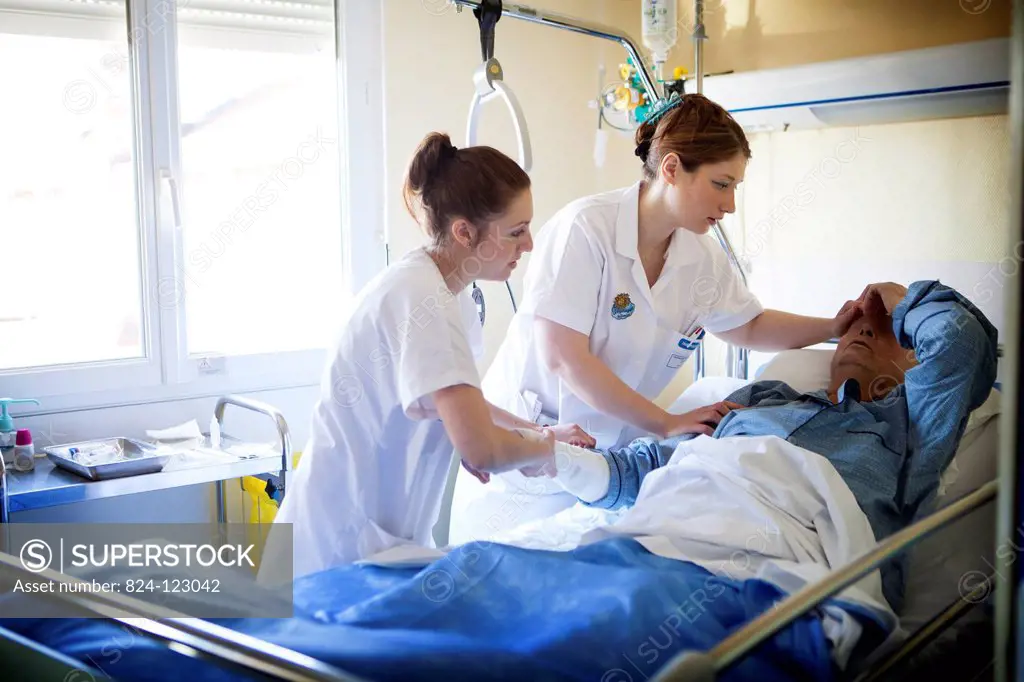 Reportage in Bligny hospital palliative care unit, Briis sous Forges, France. Two nurses looking after a patient.