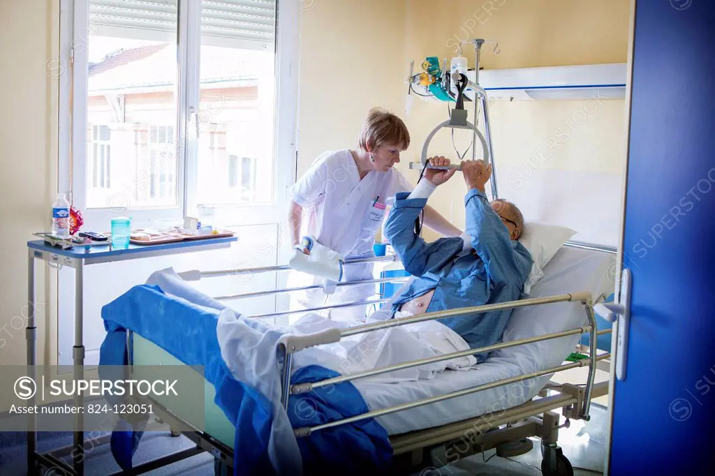 Reportage in Bligny hospital palliative care unit, Briis sous Forges, France. An auxiliary nurse looks after a patient.