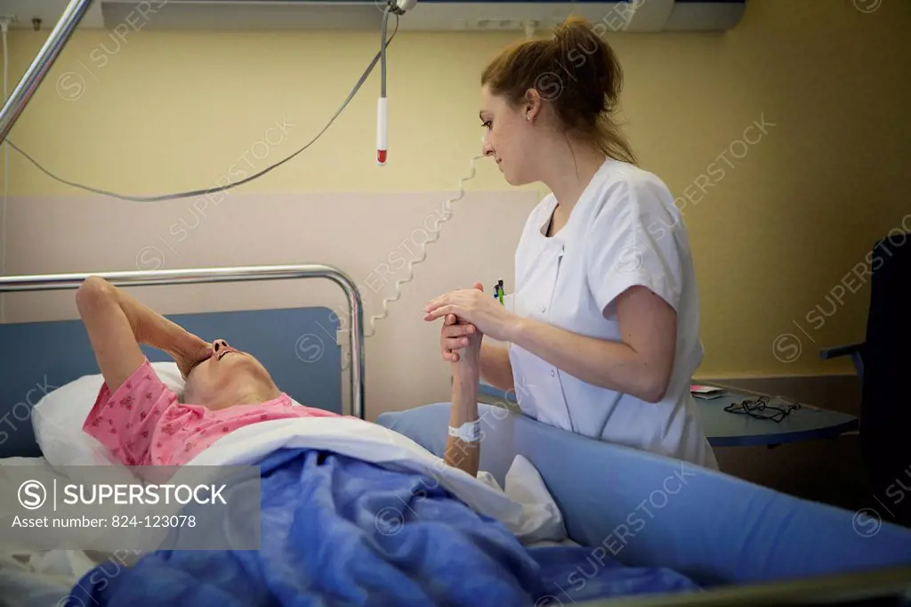 Reportage in Bligny hospital palliative care unit, Briis sous Forges, France. A nurse with a patient.