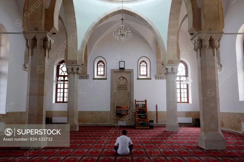 Man praying in Imam Hussein mosque, Baku.