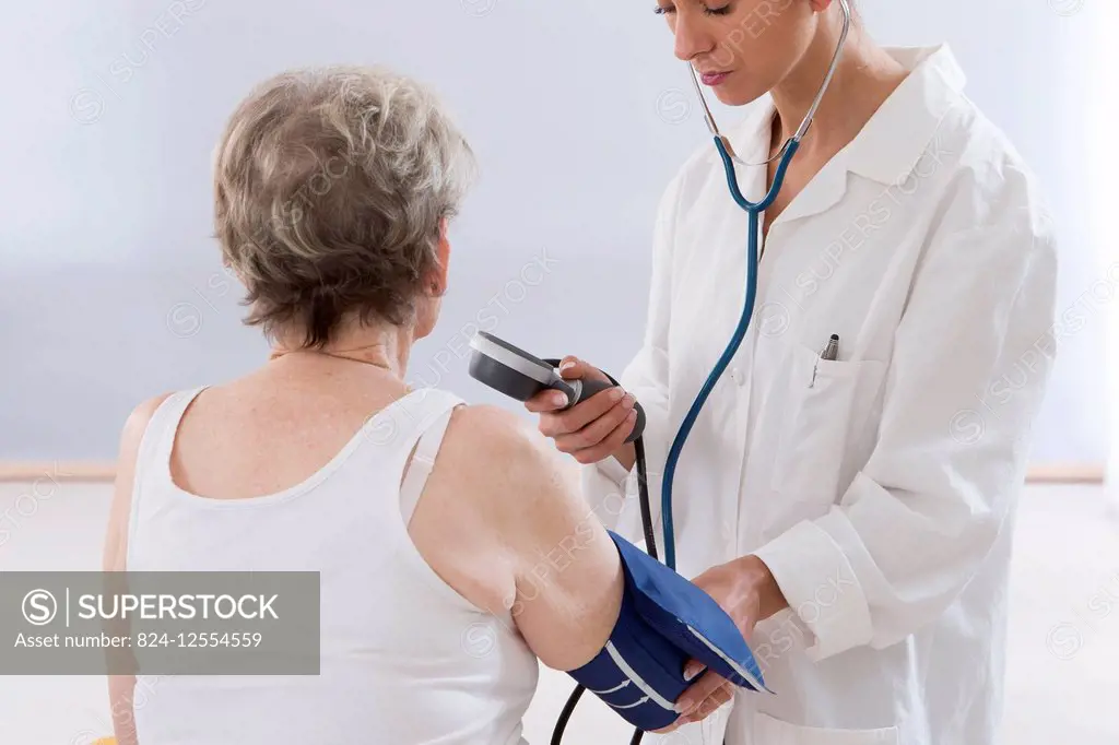 Doctor measuring a patient's blood pressure.