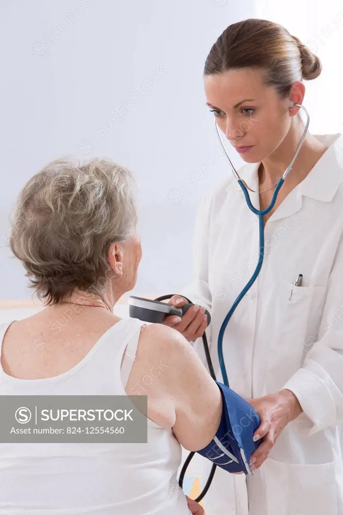 Doctor measuring a patient's blood pressure.