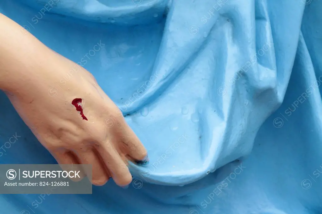 Stigma on the hand of a sculpture of Jesus Christ.