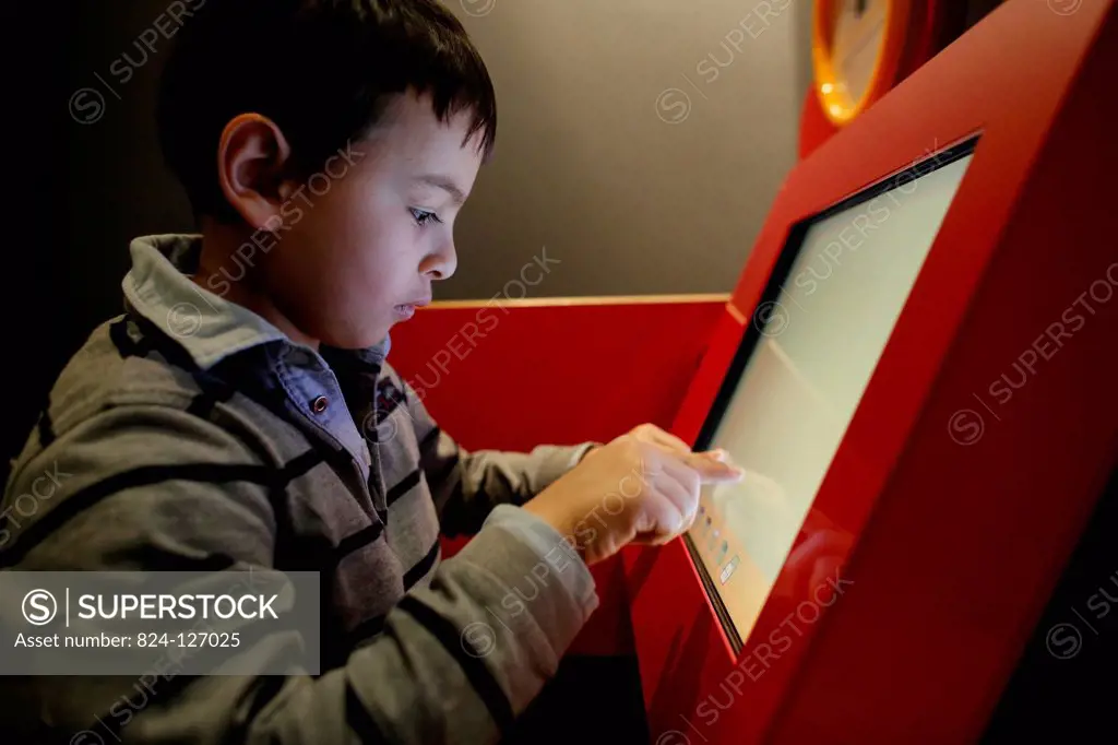 Boy drawing on a computer screen at la Cité des Sciences, Paris