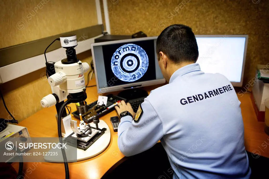 Reportage in the French National Police's Criminal Research Institute in Rosny-sous-Bois, France. Ballistics Department. Identifying a firearm through...