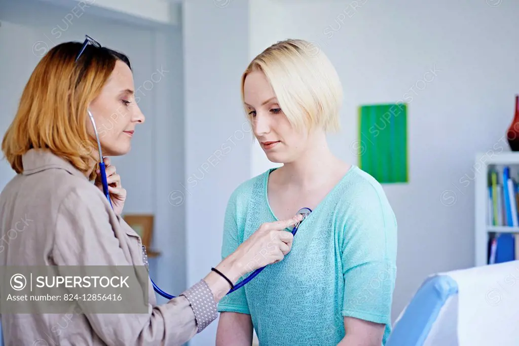 Doctor auscultating a patient.