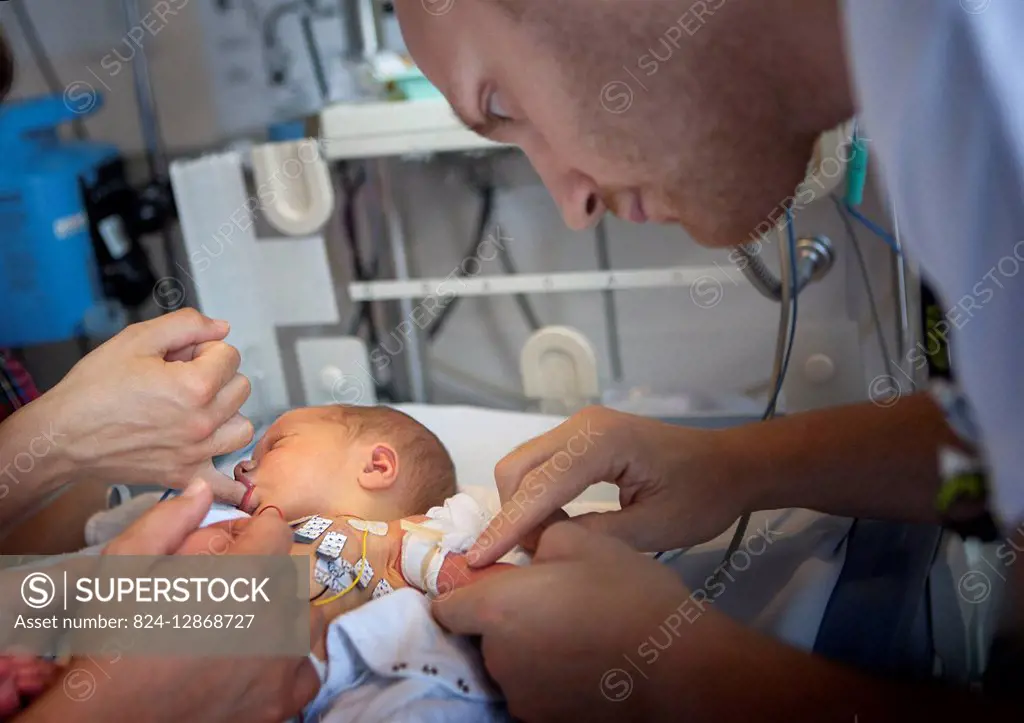 Reportage in the level 2, neonatology service in a hospital in Haute-Savoie, France. A nurse takes a blood sample from a newborn baby showing heart be...