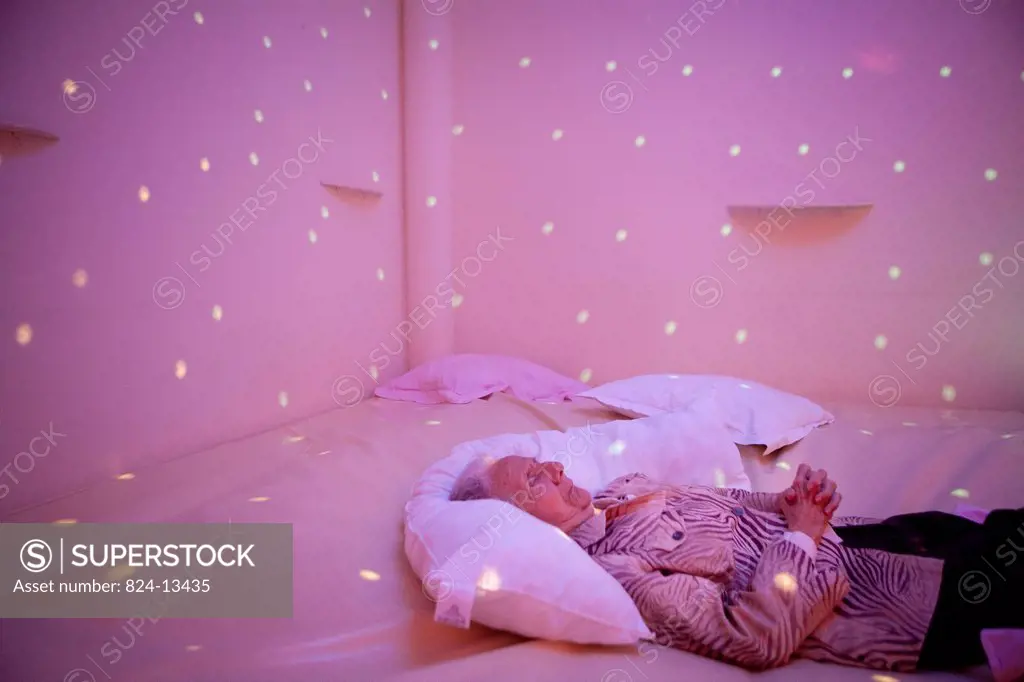 Reportage in a snoezelen room in Liège. Mony, 85, who has Alzheimer´s disease, moves around in this multi_sensory environment, which is both soothing ...