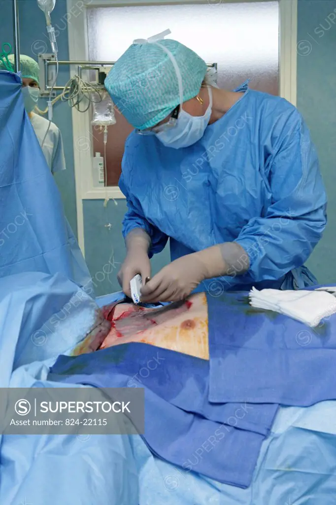 Photo essay at Rouen hospital, France. Plastic surgery. Skin grafting on the thorax of a man, the transplant is taken from the thigh of the patient.