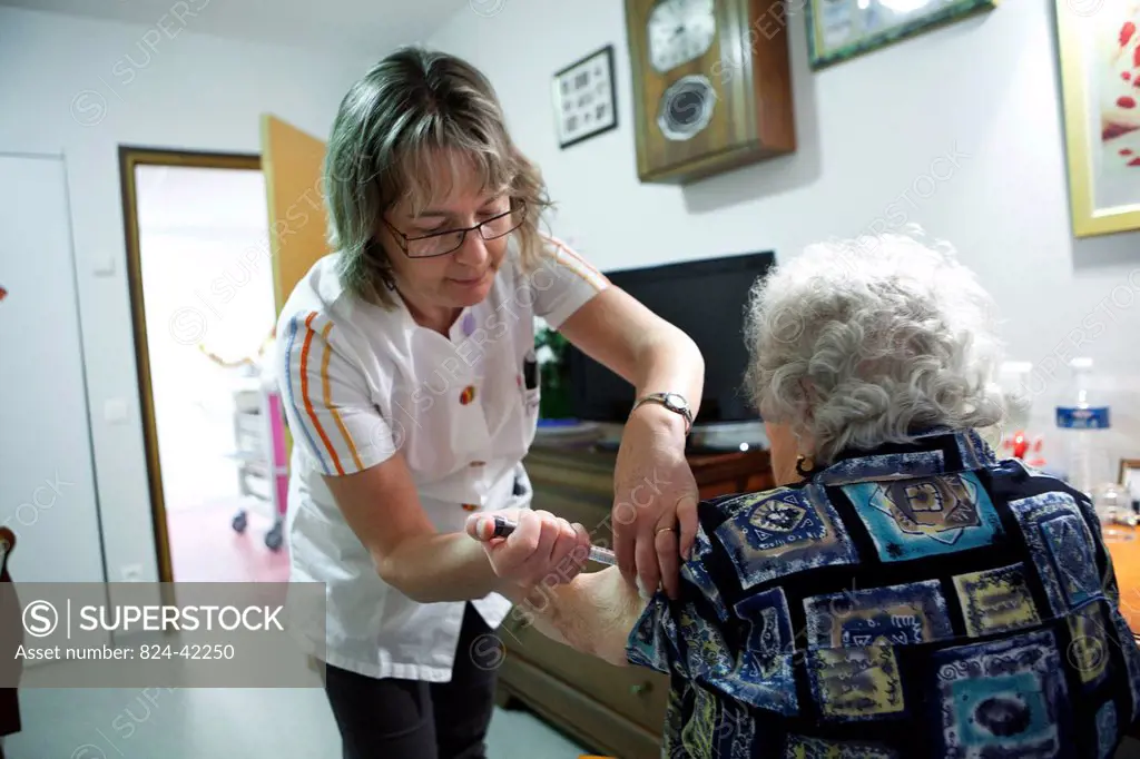 Photo essay in a retirement home at Notre_Dame_de_Gravenchon, France. Nurse.