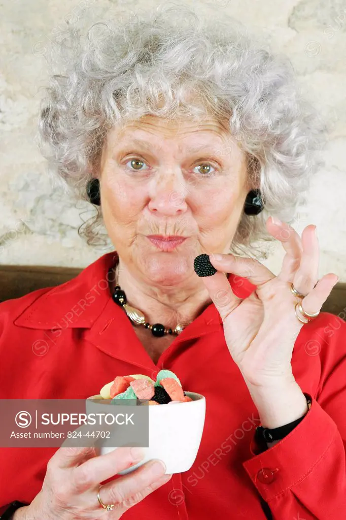 ELDERLY PERSON EATING SWEETS