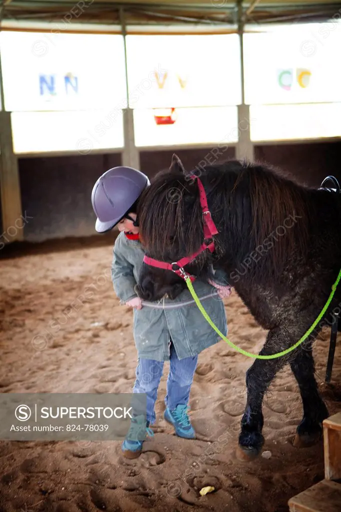Photo essay at EQUISENS, a therapeutic riding centre in Asniere_les_Dijon France. Hippotherapy session with a child having autistic disorders and psyc...