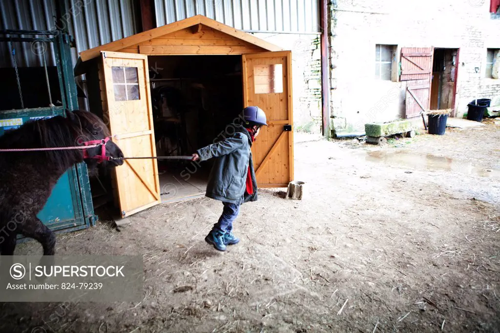 Photo essay at EQUISENS, a therapeutic riding centre in Asniere_les_Dijon France. Hippotherapy session with a child having autistic disorders and psyc...