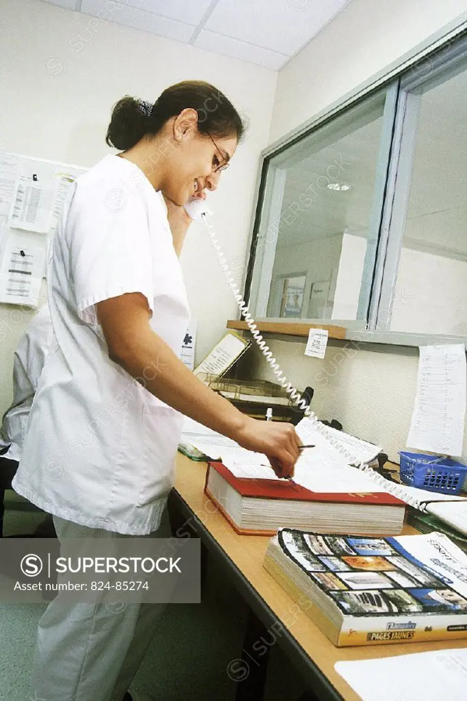 NURSE WITH PATIENT´S RECORD<BR>Photo essay.<BR>Chatellerault Hospital (Camille Guérin Hospital) in the French department of Vienne.