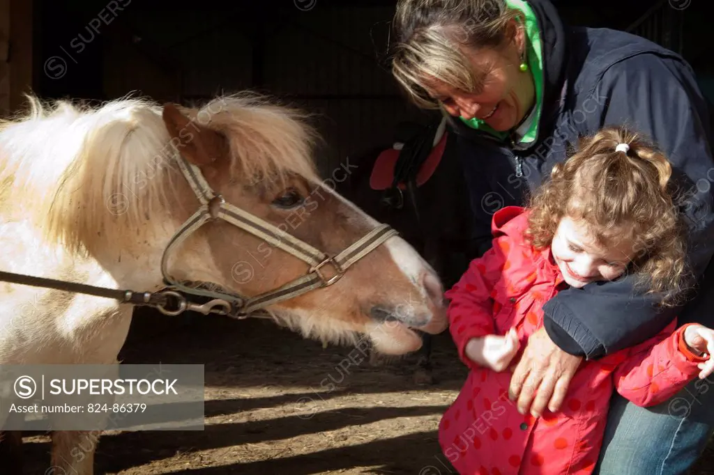 Photo essay at EQUISENS, a therapeutic riding centre in Asniere_les_Dijon France. Hippotherapy session with a child having autistic and behavior disor...