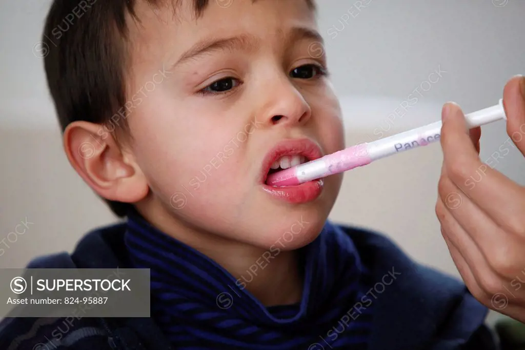 5_year_old boy taking medicine.