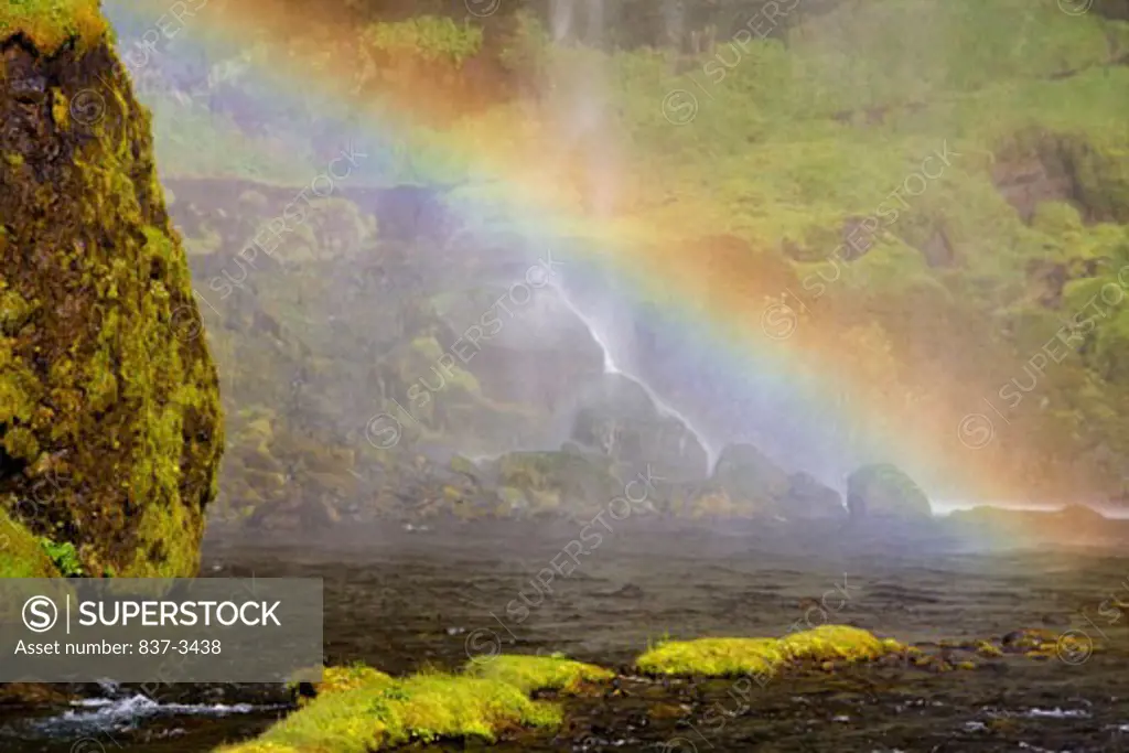 Rainbow formed at a waterfall