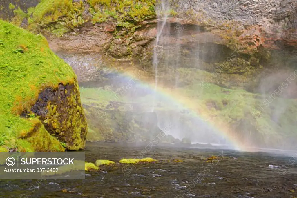 Rainbow formed at a waterfall