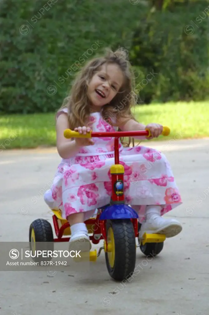 Portrait of a girl riding a tricycle