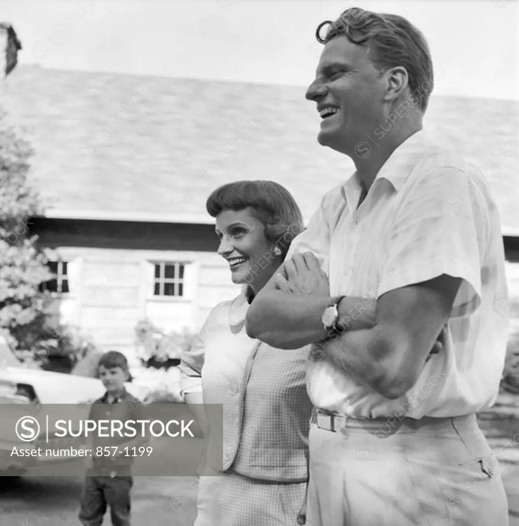 USA, North Carolina, Montreat, The Rev. Billy Graham at home with his wife, Ruth and son, Franklin in background, September 1958