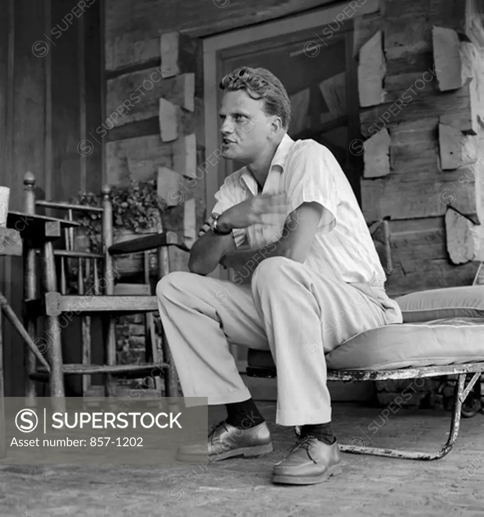 USA, North Carolina, Montreat, Billy Graham makes a point during an interview at his home, September 1958