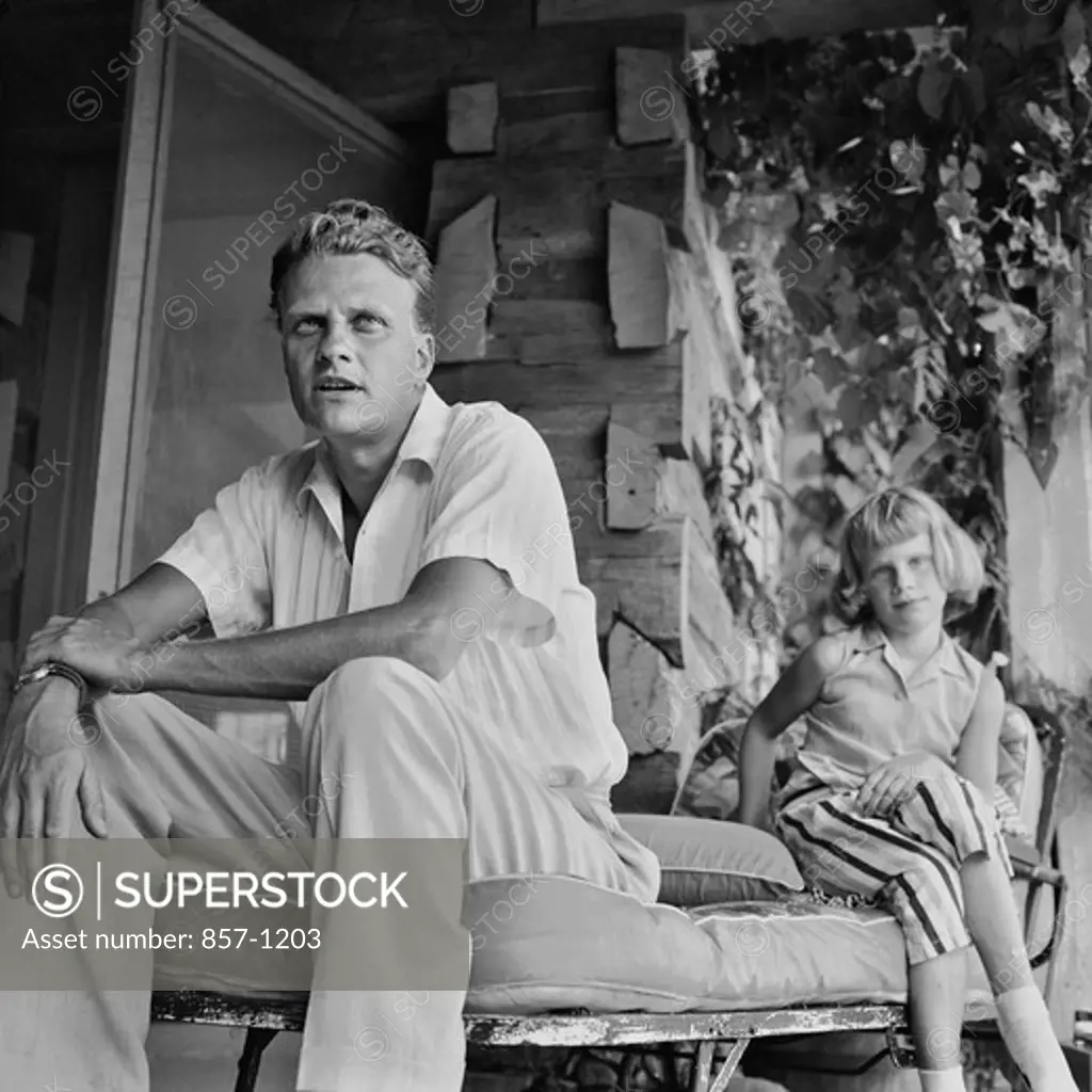 USA, North Carolina, Montreat, Billy Graham and his daughter, Anne, then age 10, at their home, September 1958