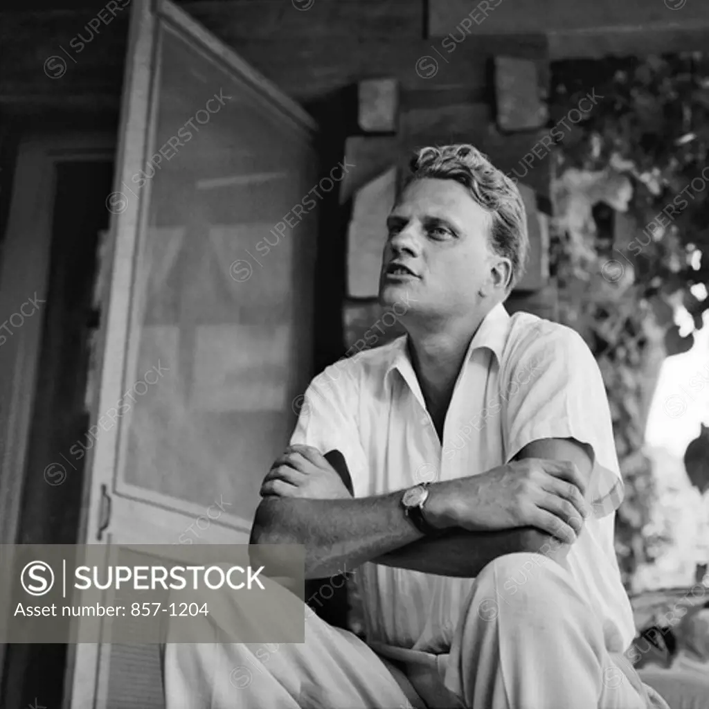 USA, North Carolina, Montreat, The Rev. Billy Graham on the porch of his home, September 1958