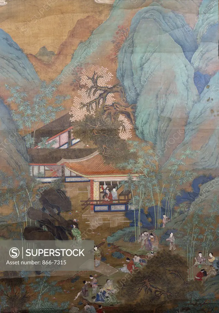 Figures at Leisure in the Garden of a Pavilion, set in a Mountainous Landscape of Blossoming Trees, Bamboo, Pine and Rockwork. A Chinese scroll painted in ink and colour on silk. 19th Century.  211 x 87.5cm.