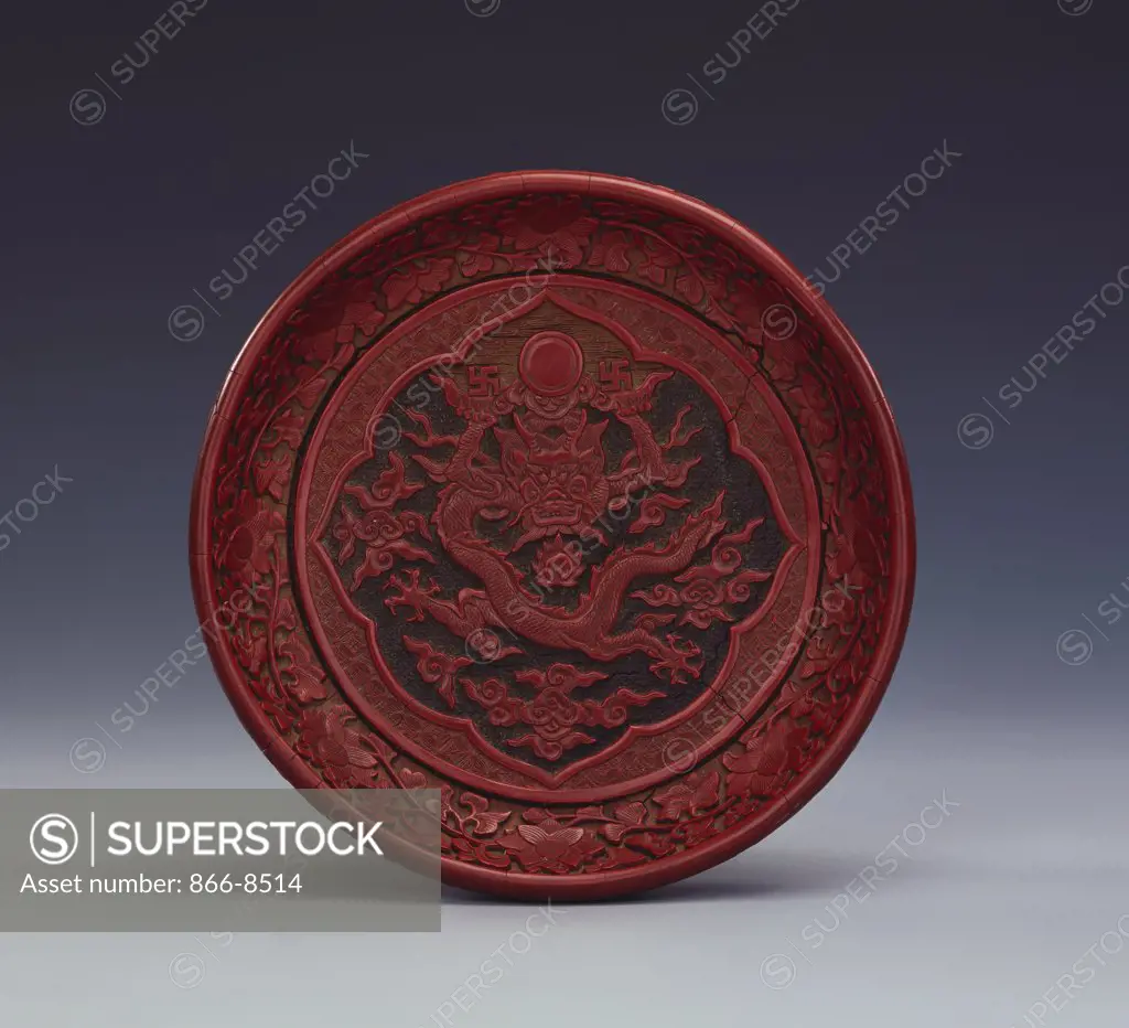 A Fine Small Ming Carved Three-Colour Lacquer Dish Depicting a Full-Faced Cinnabar-Red Dragon. Jiajing / Wanli, 16.5cm diam.