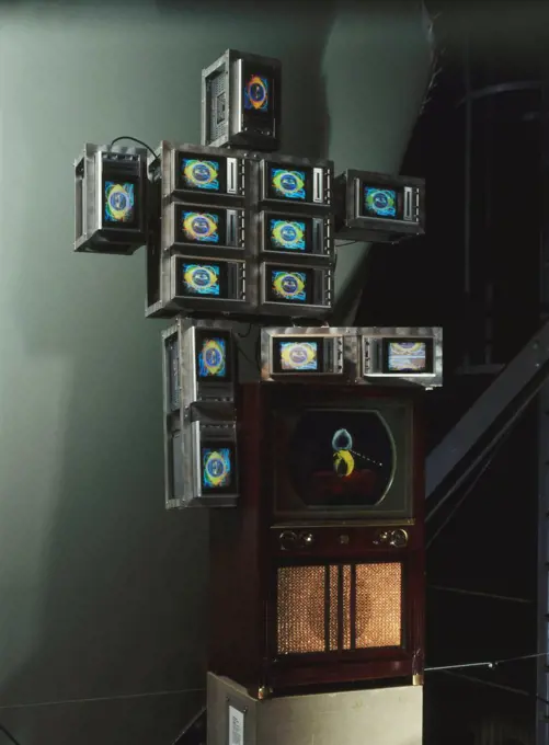 High Tech Baby. Nam June Paik (1932-2006). 13 colour TV sets, aluminium framework, TV cabinet screen, acrylic paint, videodisc and player. Executed in 1986. 203 x 108 x 51cm.