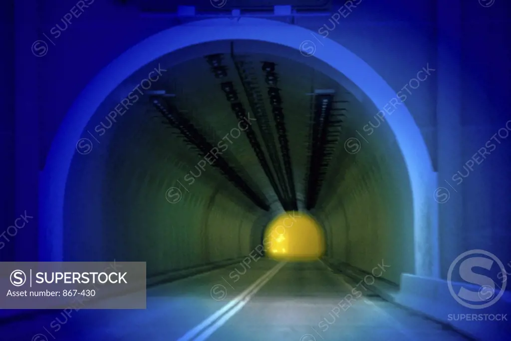 View of a headlight glowing in a tunnel