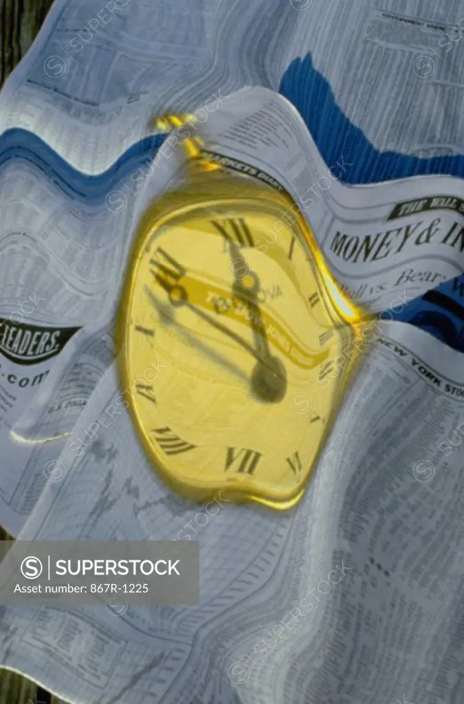 Clock superimposed over financial reports